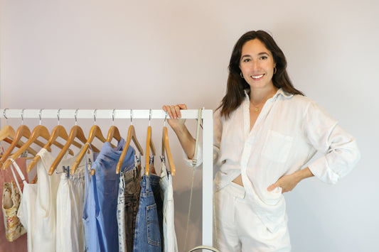 Pip Dracakis standing next to a rack of clothing